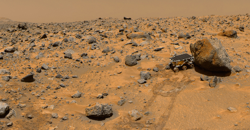 The Mars Pathfinder lander took this photo of its small rover, called Sojourner. Here, Sojourner is investigating a rock on Mars. Image credit: NASA/JPL-Caltech